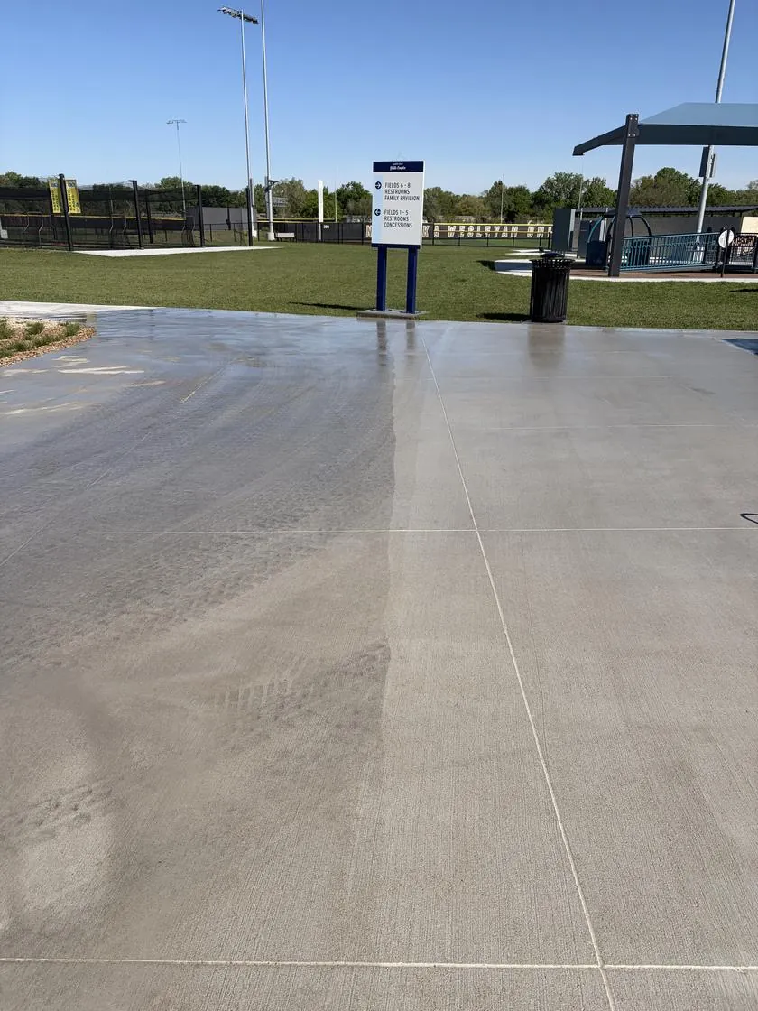 Concrete plaza, washed on the right and not yet washed on the left